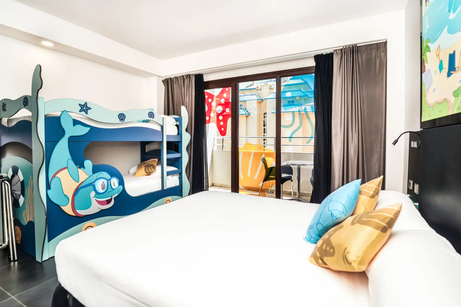 Baku Room at the Bakour La Manga Splash hotel: themed family room with bunk beds decorated with the Baku mascot and a terrace