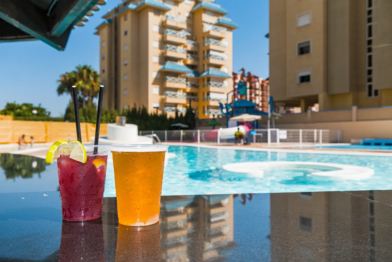 Cool drinks at the pool bar of the Bakour La Manga Splash hotel with the pool and slides in the background