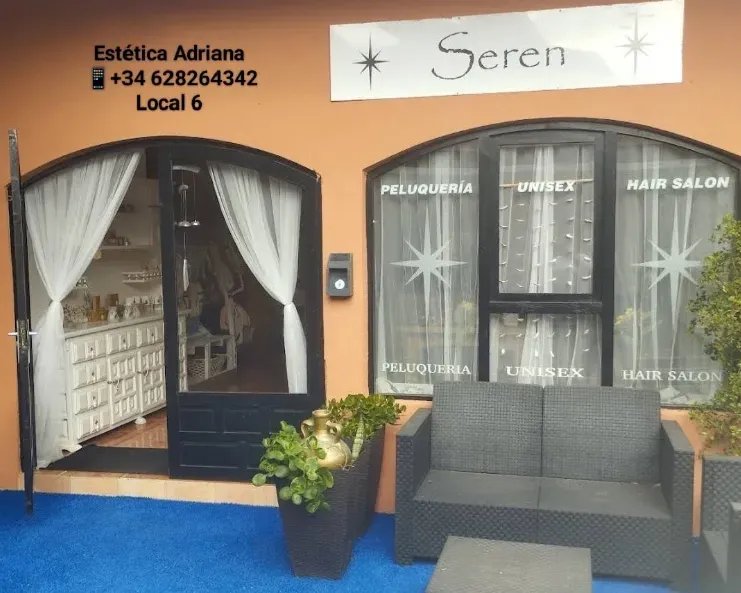 Façade of Estética Adriana in unit 6 on the Gran Vía in La Manga, with white curtains and an outdoor sofa by the entrance