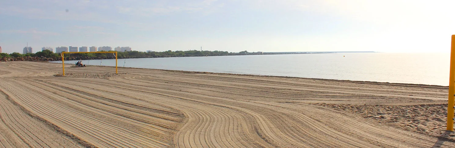 Mediterranean coastline at Playa del Estacio, with sand in the foreground and a wave-free sea