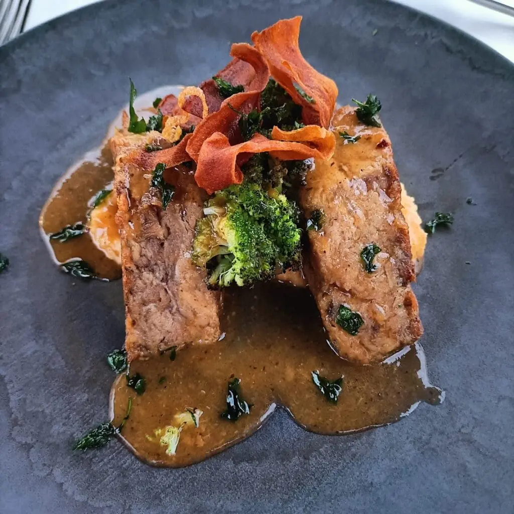 Meat dish presented at Abela Teresa, a Mediterranean restaurant in La Manga Club