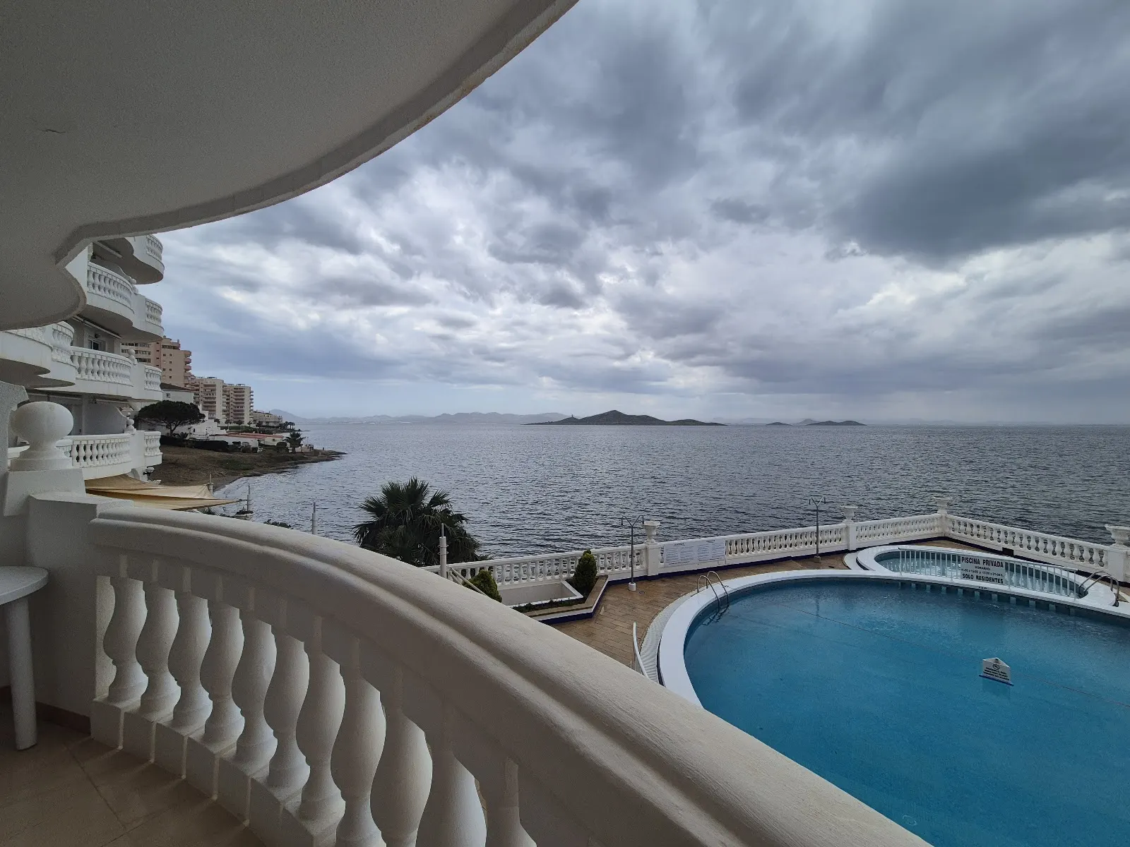 Vue sur la piscine et Mar Menor depuis un balcon de Apartamentos Dominique