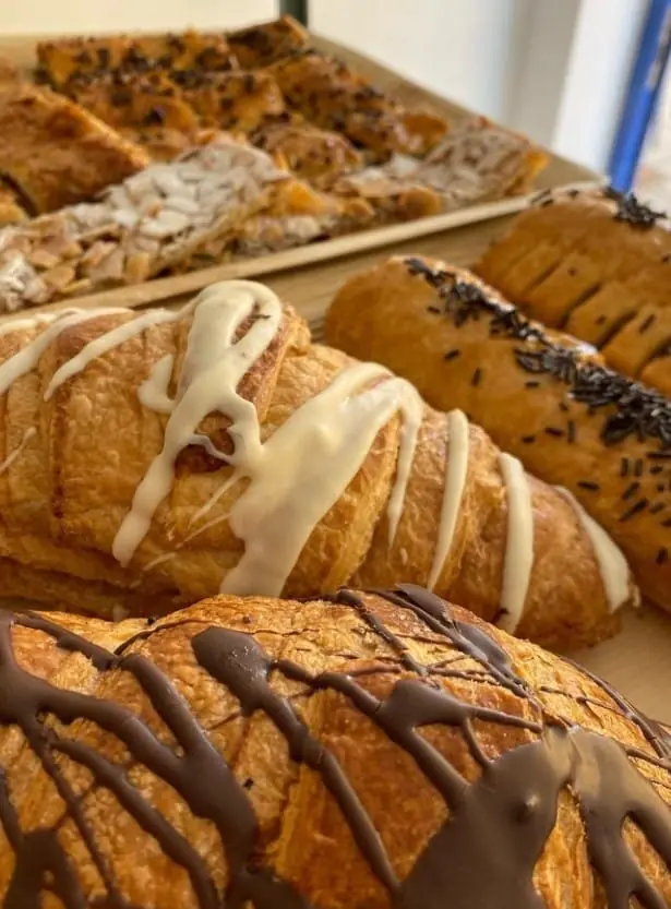 Chocolate and almond-filled croissants on the counter at Café de Levante