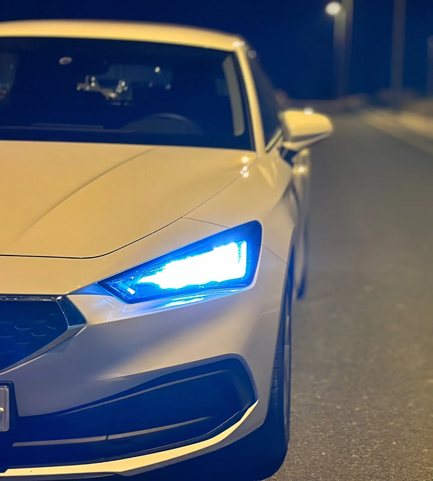 Front eines Mietwagens von Conccordcars Mediterráneo mit eingeschalteten LED-Scheinwerfern bei Nacht