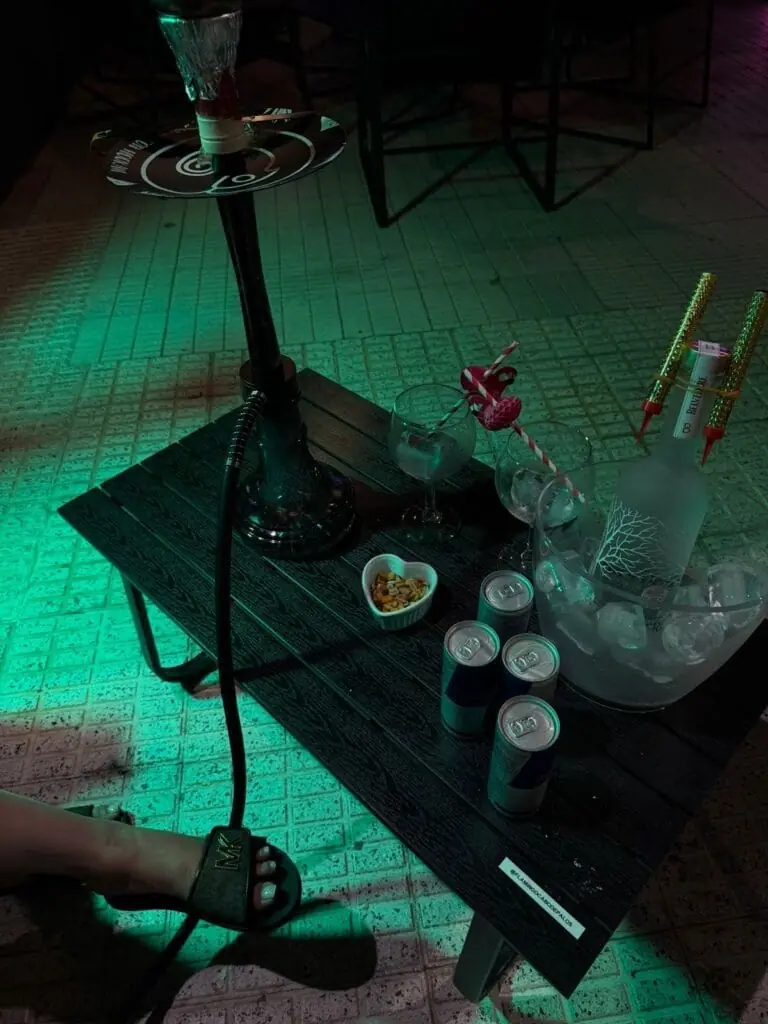 Tisch mit Shisha und Getränken auf der Terrasse von Flamingo Beach