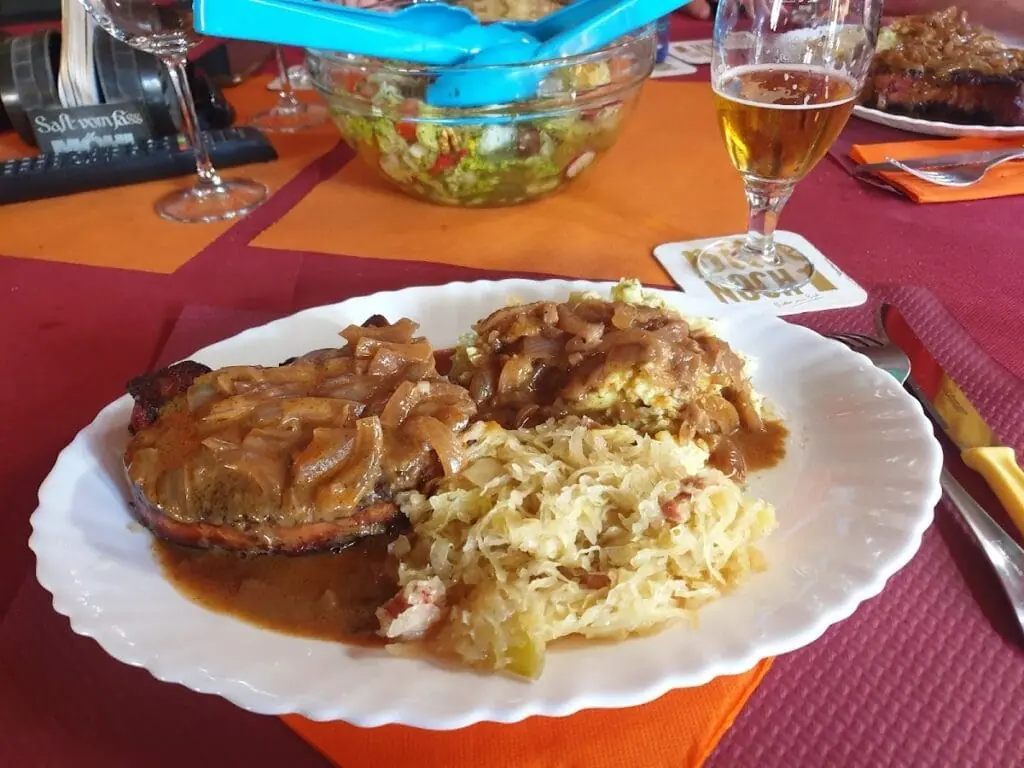 Pork knuckle with sauerkraut served at Hans Bar
