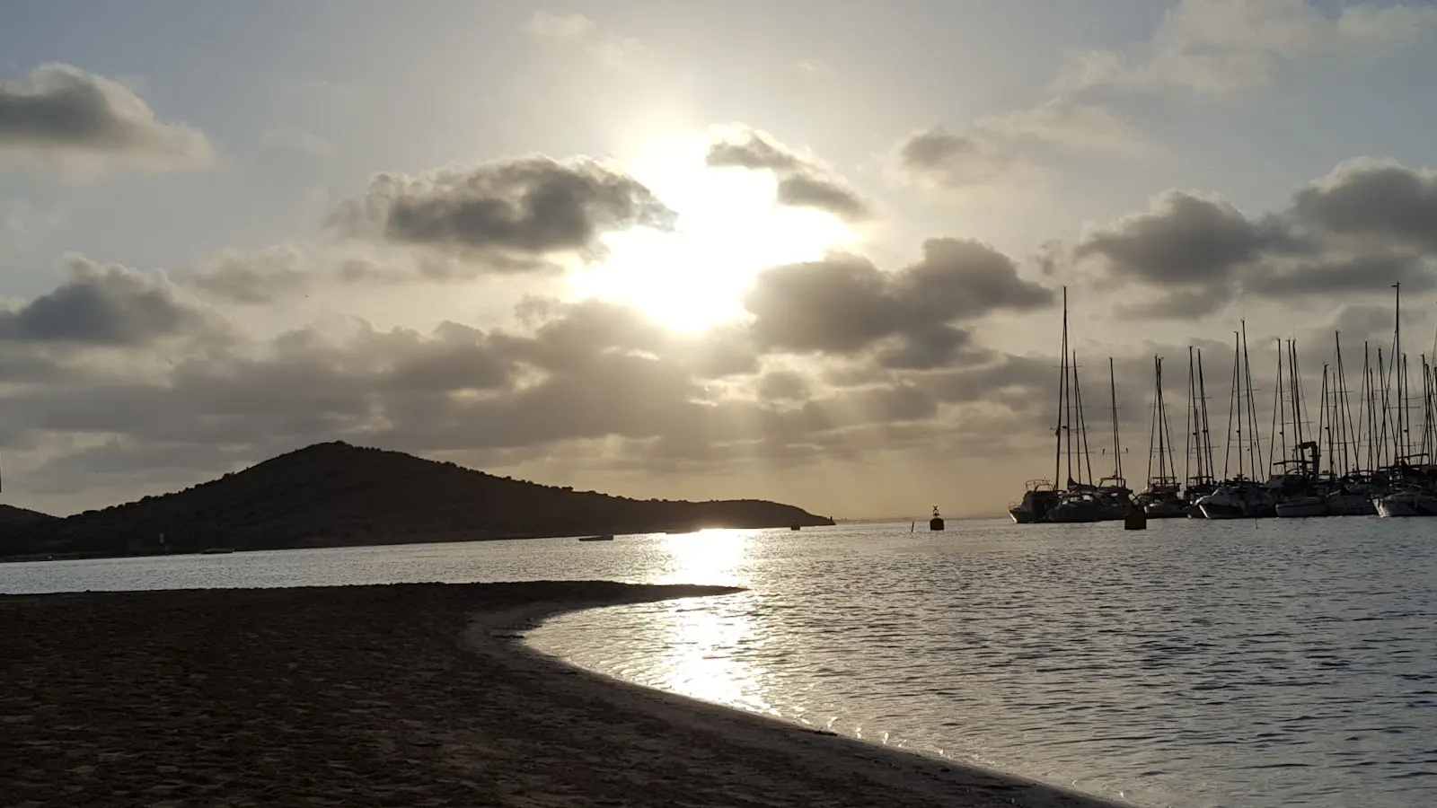 Sunset on the Mar Menor with moored sailing boats and an island in the background