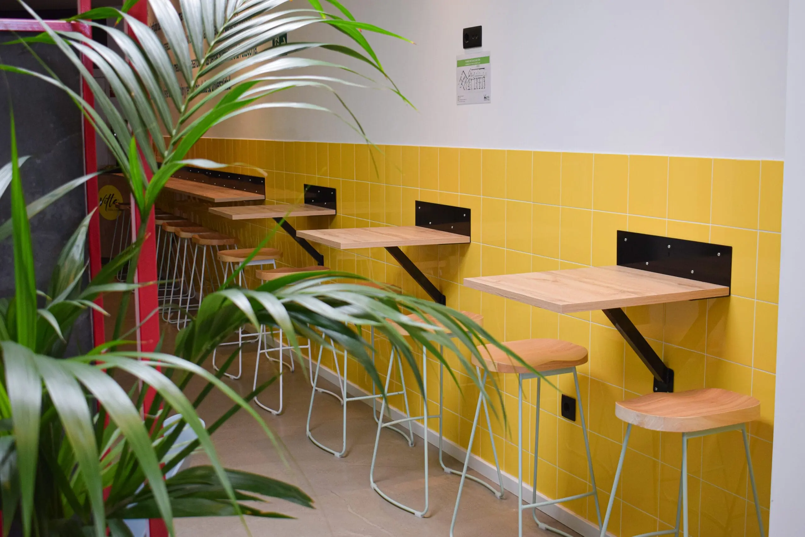 Shared area with high tables at Konk Hostel in La Manga del Mar Menor