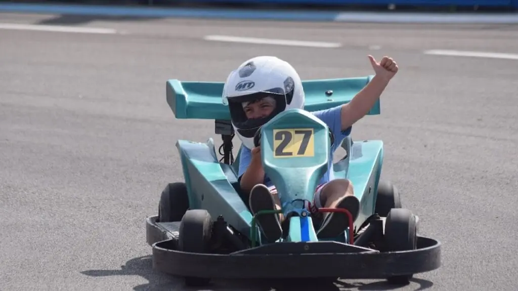 Child wearing a helmet driving a kart at the La Manga Gokart track in Cabo de Palos