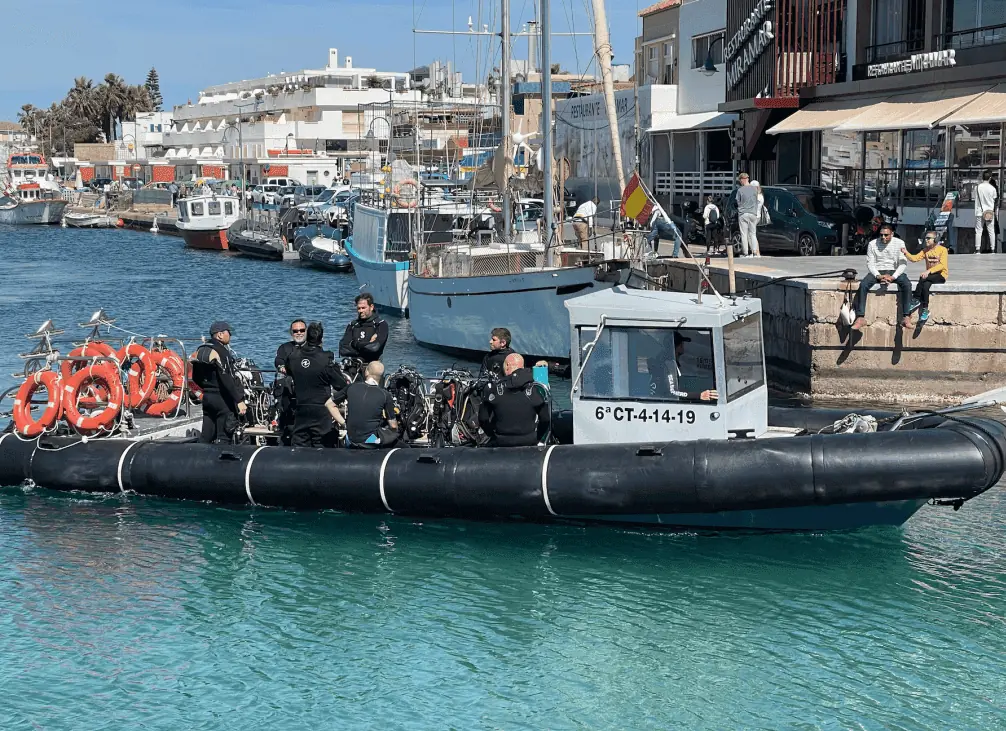 Group of divers preparing their equipment on the Mangamar Dive Center boat in Cabo de Palos harbour