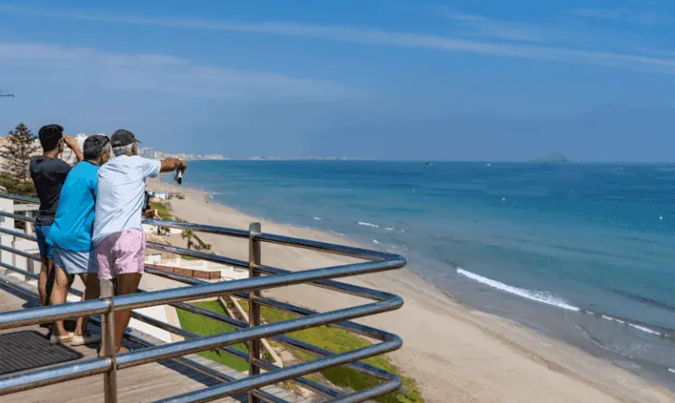 People at a viewpoint above Monteblanco beach