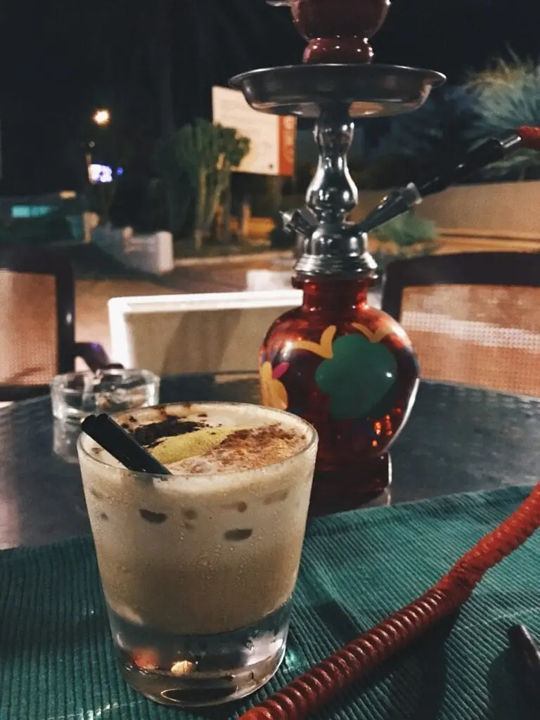 Cocktail served beside a shisha on the terrace at Rhapsody