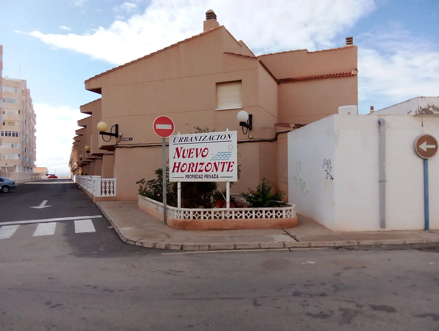 Entrance sign and exterior of Urbanización Nuevo Horizonte in La Manga