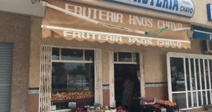 Exterior de Frutería Hnos. Chavo en La Manga del Mar Menor, con toldo naranja, cajones de fruta fresca expuestos y rótulo doble bien visible