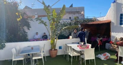 Terraza exterior del Restaurante Stromboli en La Manga del Mar Menor con mesas blancas, césped artificial y clientes disfrutando al sol