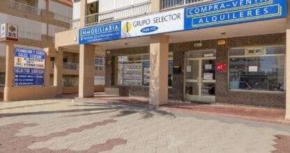 Oficina exterior de Grupo Selector con carteles de compra-venta y alquileres desde 1975, inmobiliaria en La Manga del Mar Menor