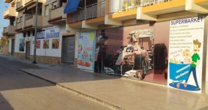 Fachada exterior del Supermercado Islas Menores con murales decorativos en la calle, La Manga del Mar Menor